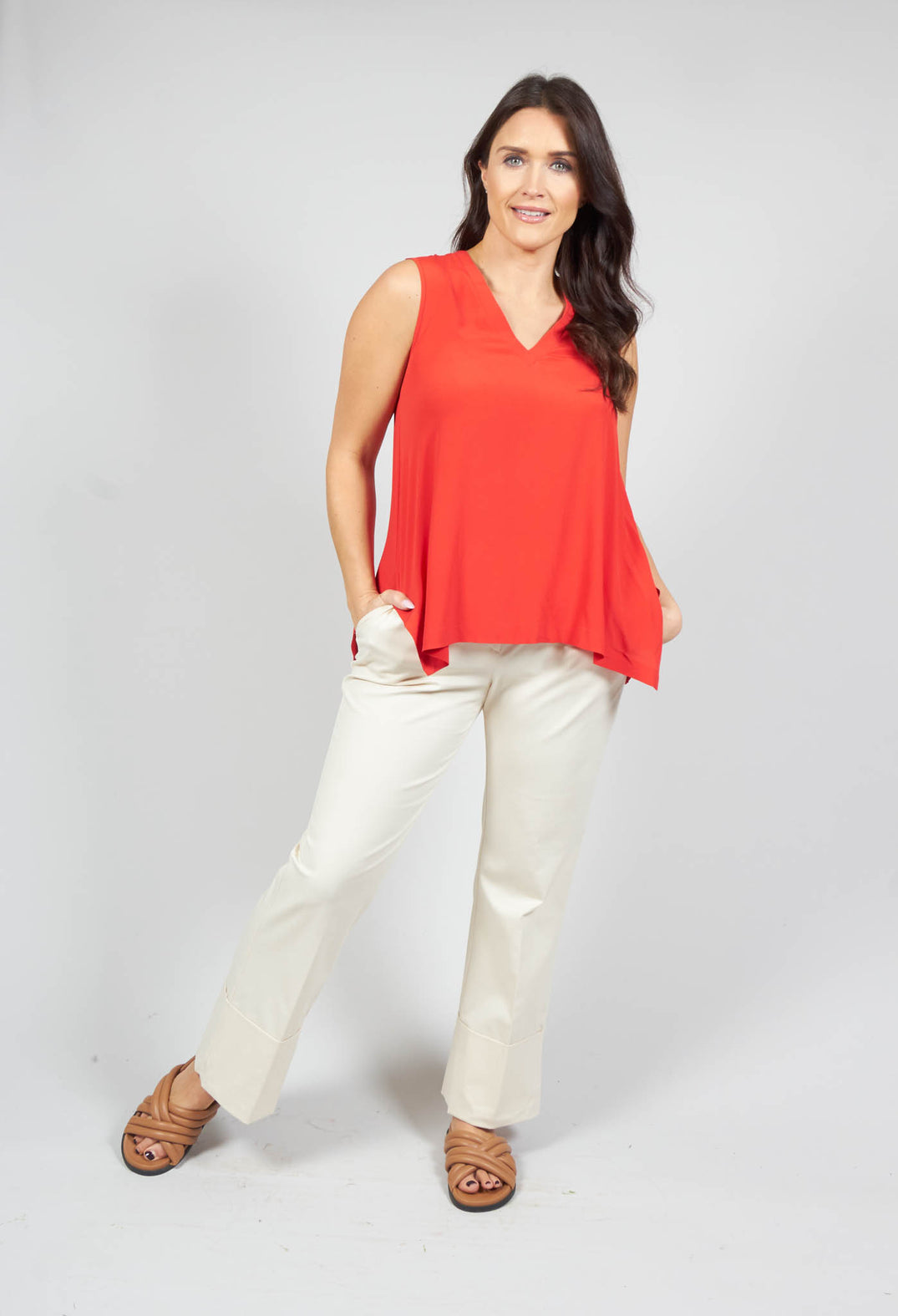 lady wearing a red v neck sleeveless top in a loose fit
