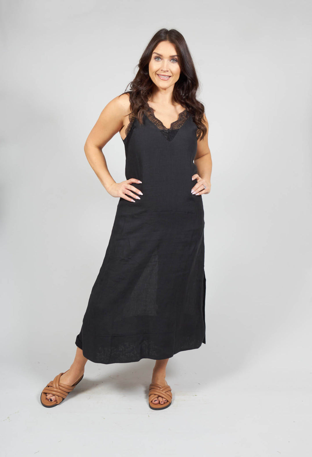 lady smiling and wearing a midi dress with lace detail in black