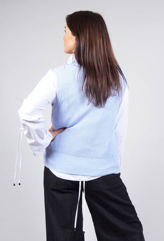 lady wearing v neck crochet tank top in baby blue