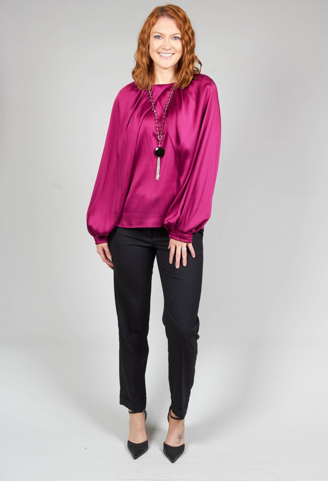 lady wearing a crepe shirt in metallic pink