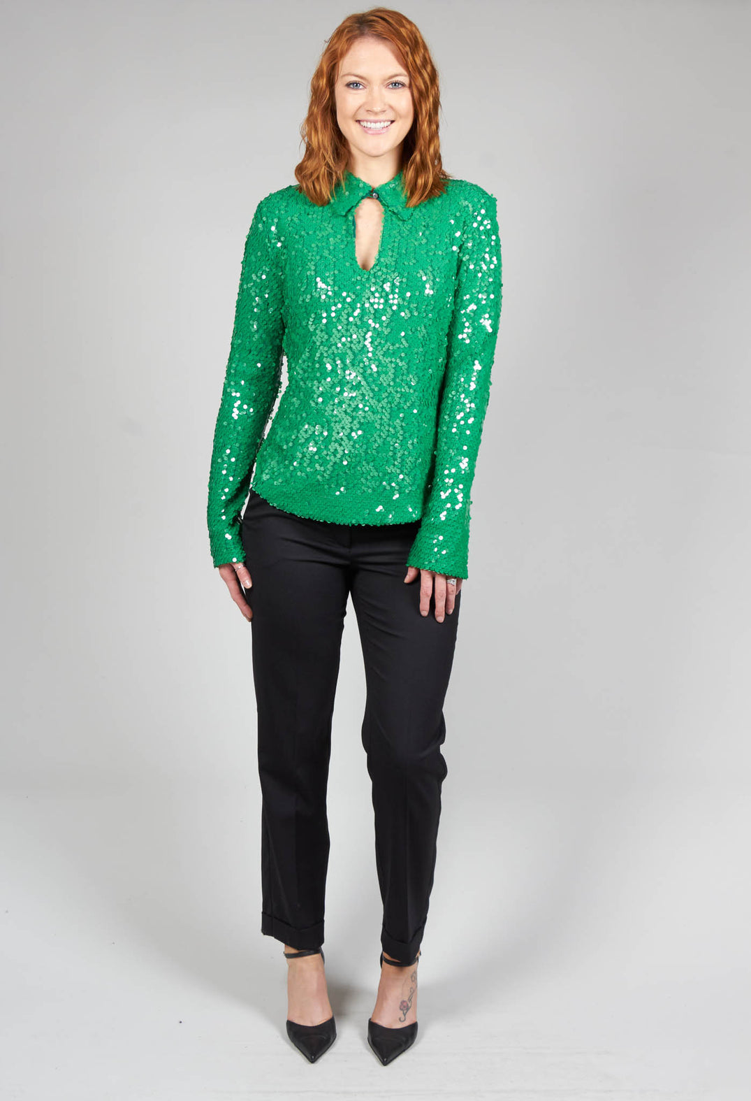 lady smiling in her green sequin blouse 