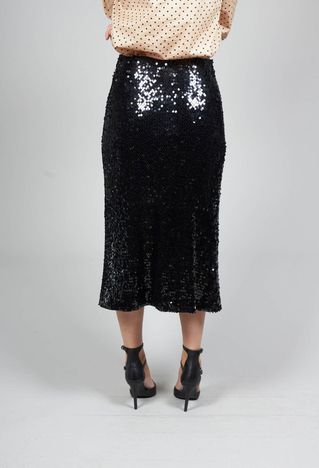lady wearing black sequin skirt 