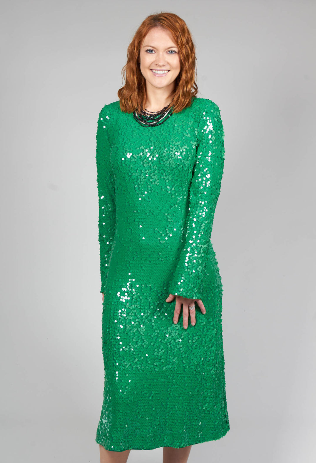 lady smiling in her green sequin detail dress