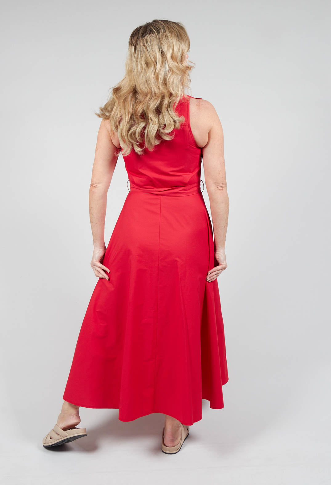 angle from behind of lady wearing red collared sleeveless dress