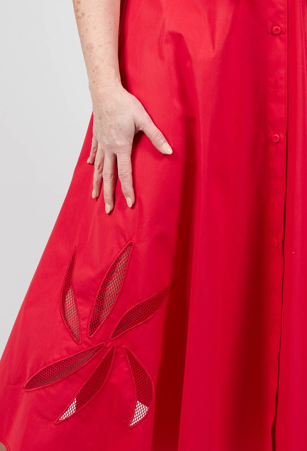 beautiful red collared sleeveless dress close up shot and cut out detailing