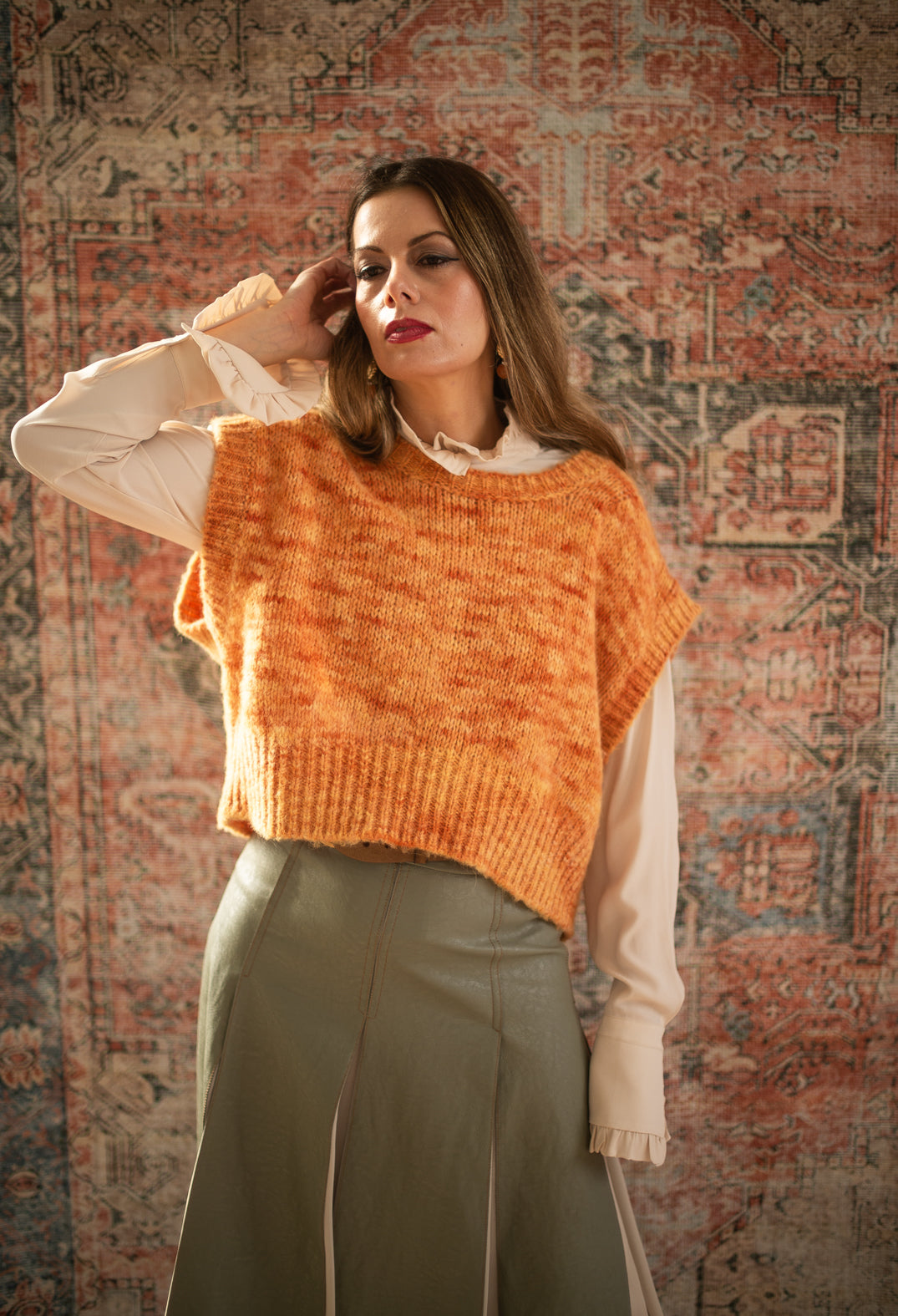 lady wearing an orange knitted vest