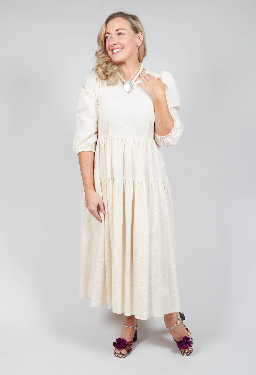 lady smiling wearing the beatrice b cream shift dress