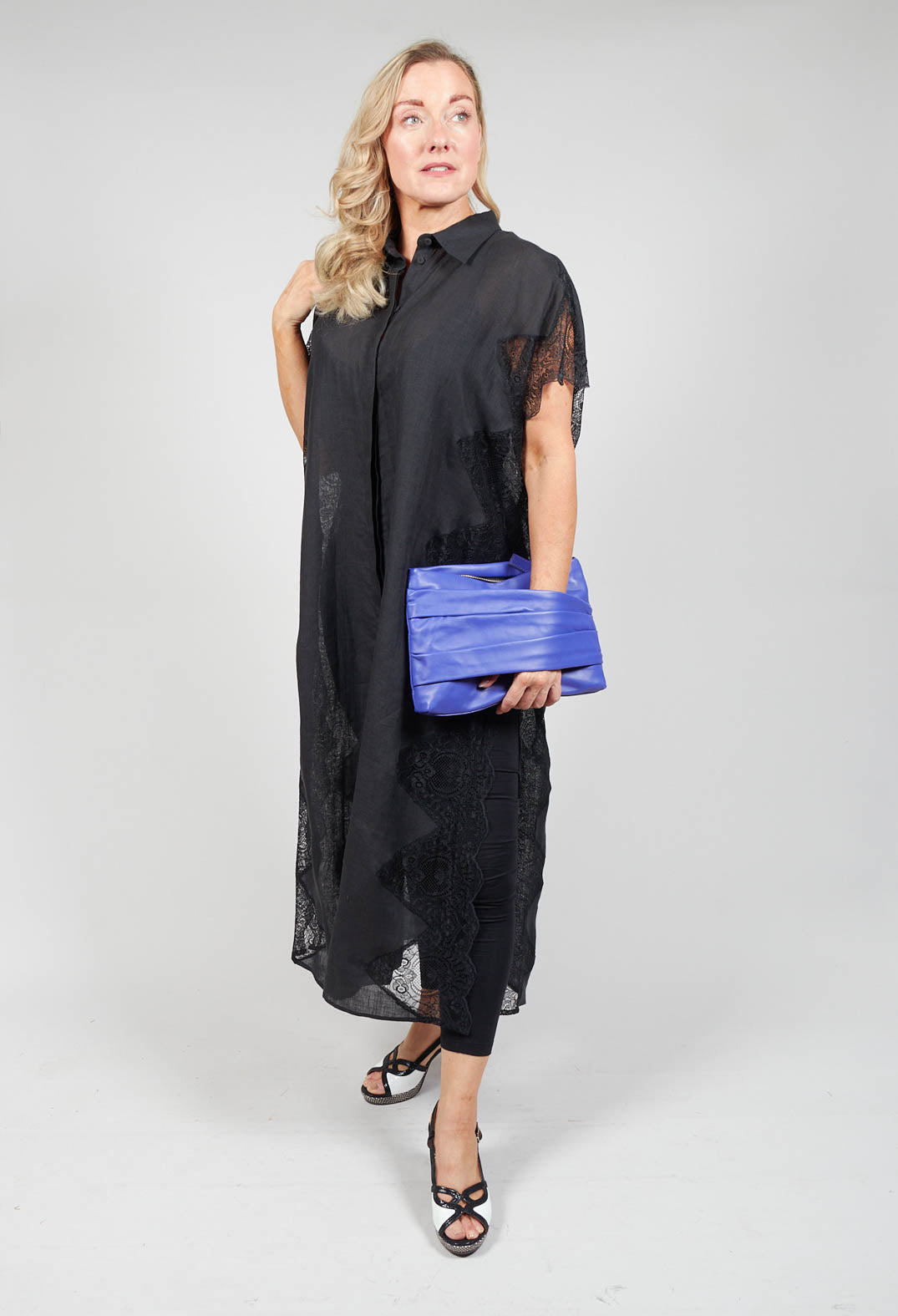 lady wearing a black shirt dress with lace detail