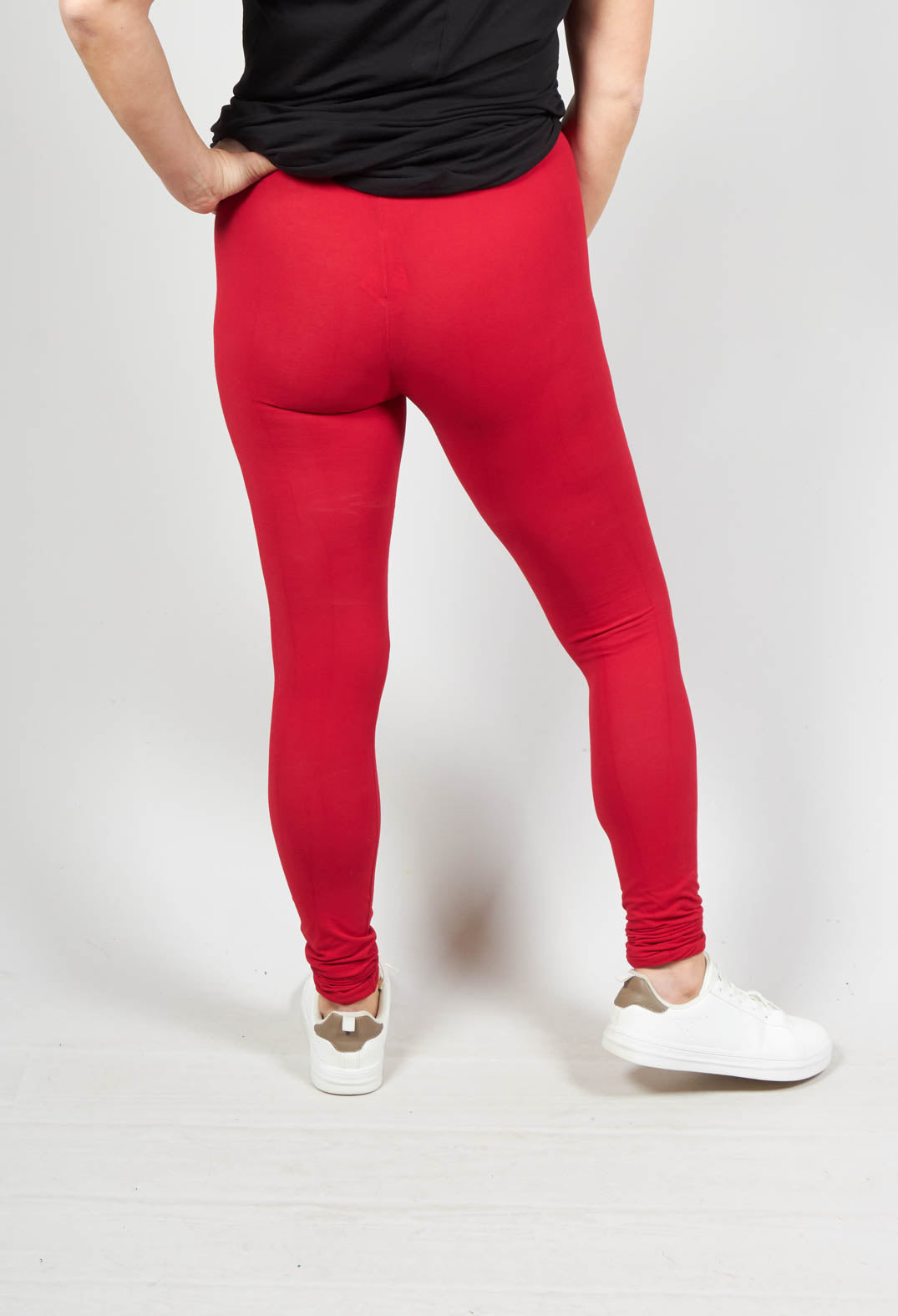 behind shot of female wearing red leggings with an elasticated waist