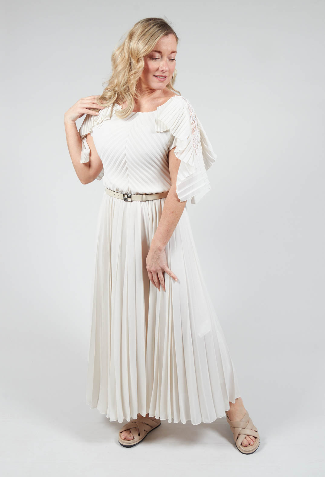 lady wearing neutral colour maxi dress with a waist belt and light colour sandals