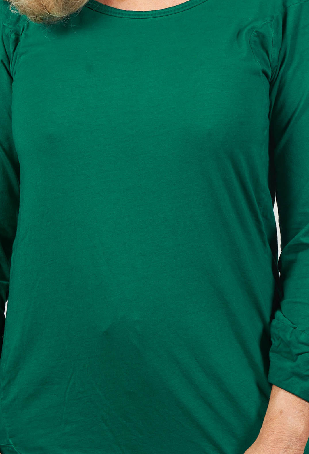 close up of green long sleeved t shirt with round neck