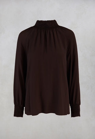 brown ruffled blouse
