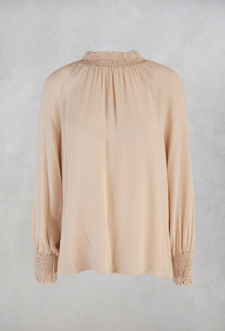 sand ruffled blouse with long sleeves and collar
