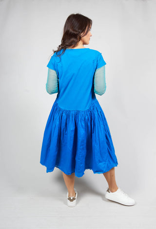 behind shot of a ladies short sleeved jersey dress in blue with gathered waist detail