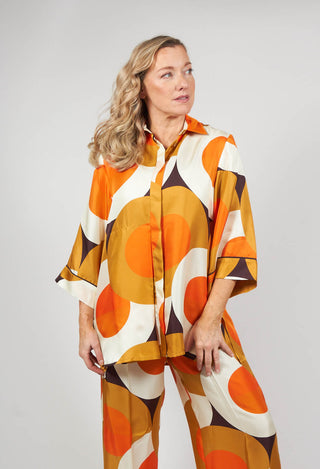 pretty lady wearing Beatrice B silk blouse in circle print