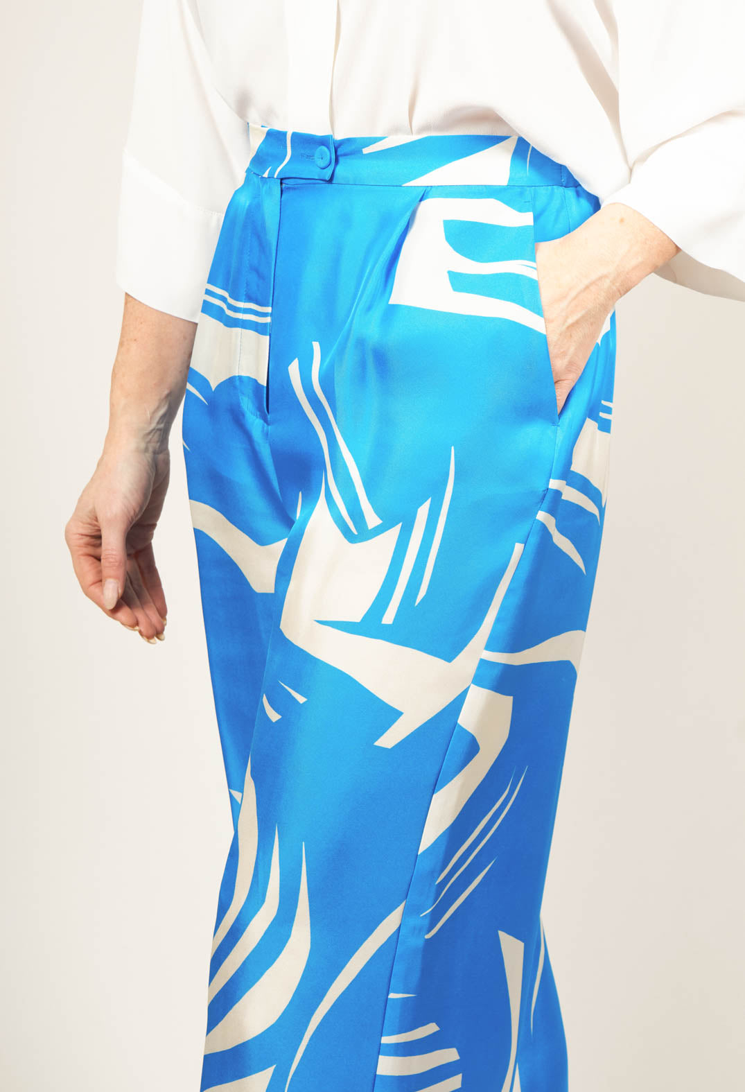 blue silk trousers with button fastening and front pockets