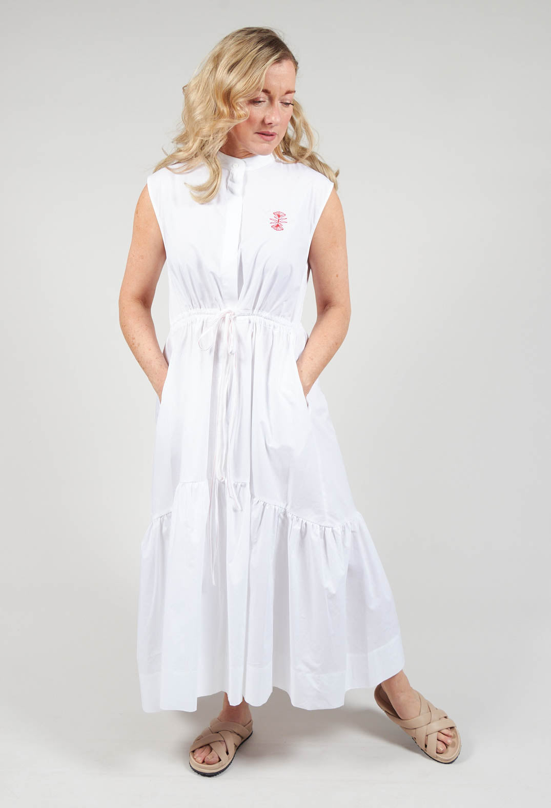 lady wearing Beatrice B sleeveless dress in white