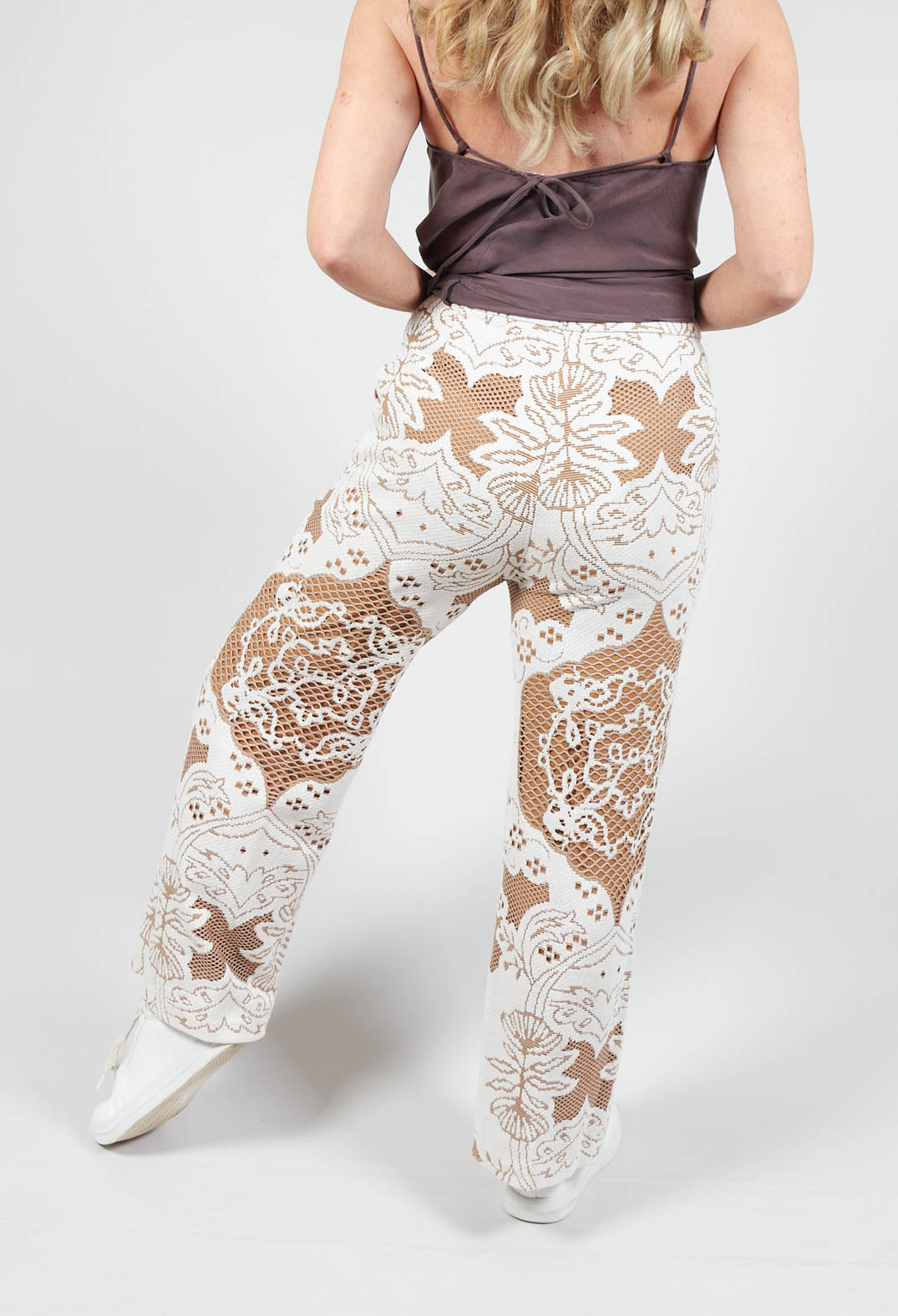 behind shot of Beatrice B straight leg trousers in brown with lace detail