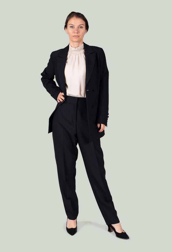 lady wearing black tailored trousers with a suit
