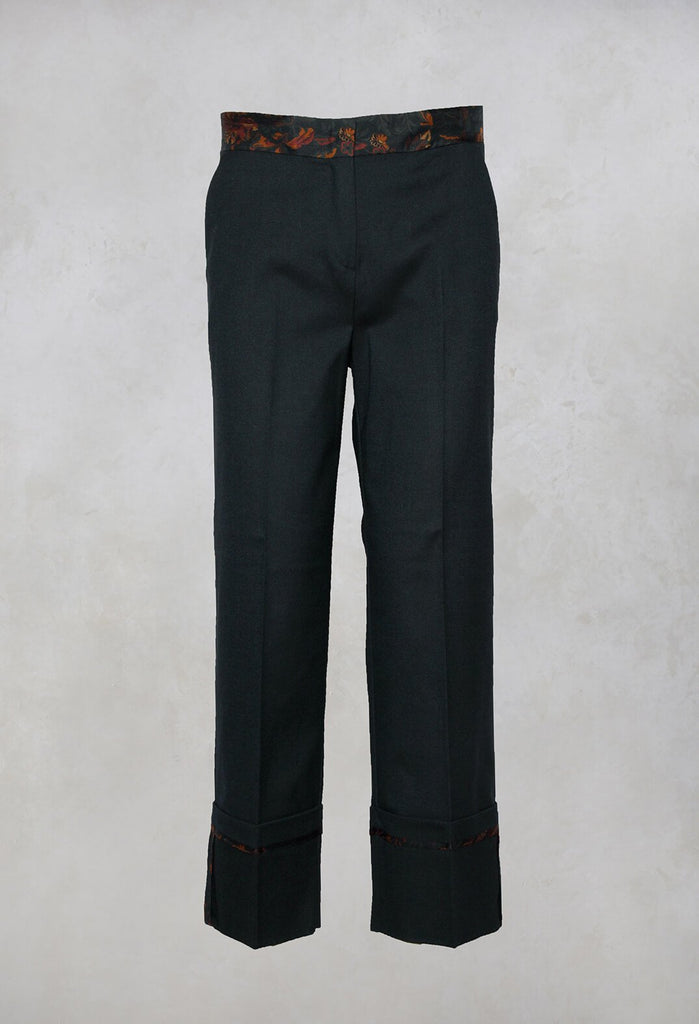 dark green tailored trousers with floral trim