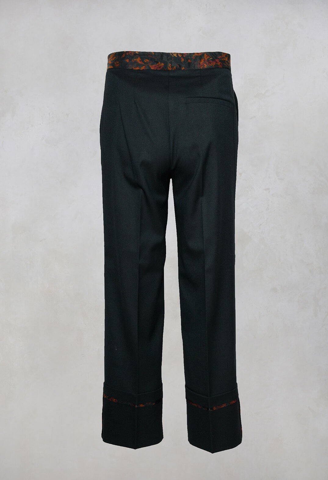 dark green tailored trousers with floral trim detail