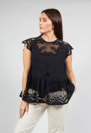 lady wearing a Beatrice B black top with lace detail